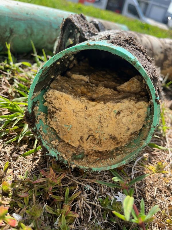 Grease set up solid in a sewer line. Cabling punches a hole through it — jetting takes it back to bare pipe.