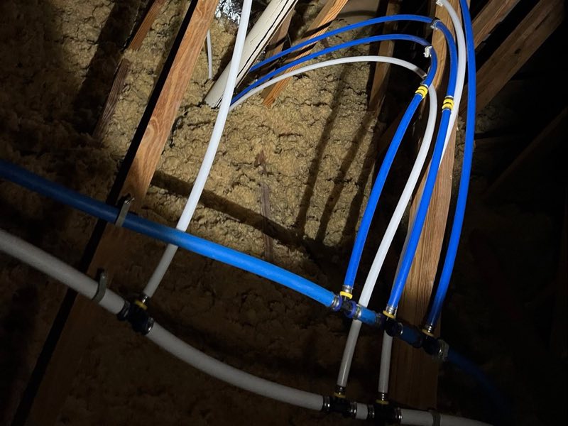 PEX branch lines secured along the trusses on a repipe
