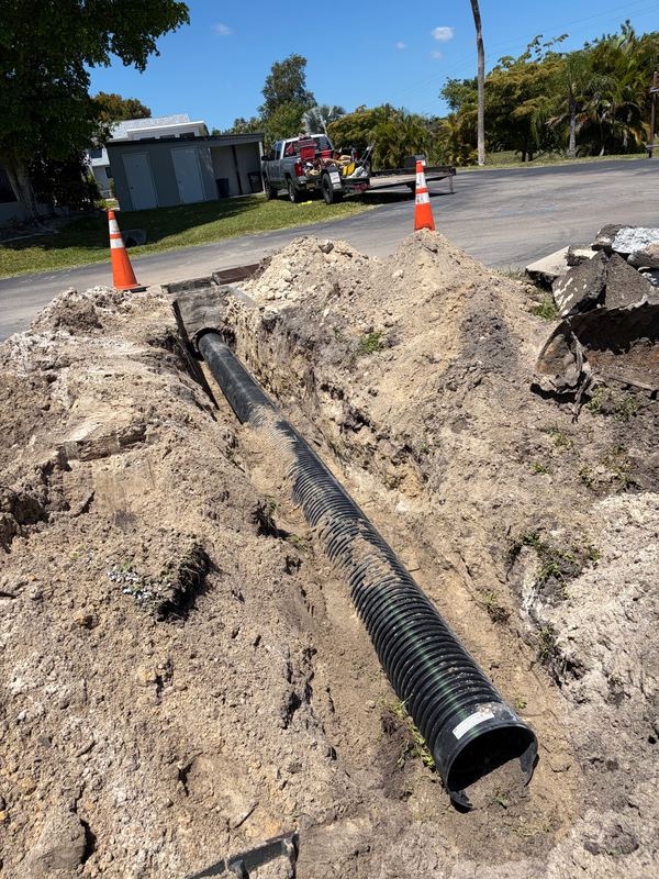 New sewer line in an open street trench before backfill