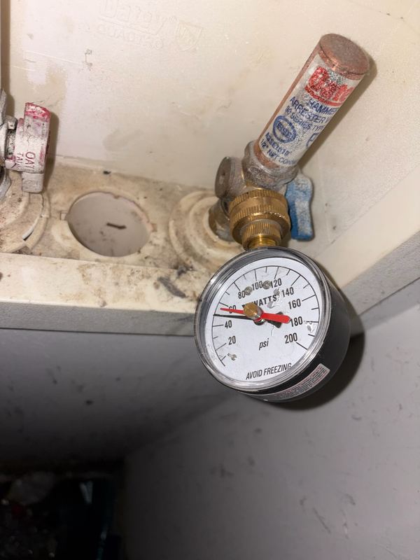 Pressure gauge on the service — the first check on any water complaint